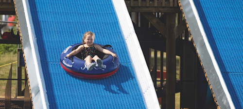 A young girl tries out the Tube Slide at Haven Devon Cliffs - a new activity for 2023