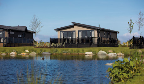 A Lodge next to a lake on our Haggerston Castle Holiday Park.