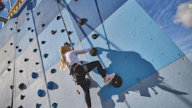 Helmet and ropes at the ready before you take to the climbing wall
