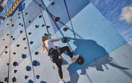 Helmet and ropes at the ready before you take to the climbing wall