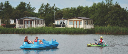 A pedalo on the lake and kayak on the lake