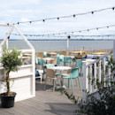 The decked outdoor terrace area at Kent Coast Yacht Club looks out over the Thames estuary.