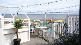 The decked outdoor terrace area at Kent Coast Yacht Club looks out over the Thames estuary.