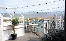 The decked outdoor terrace area at Kent Coast Yacht Club looks out over the Thames estuary.