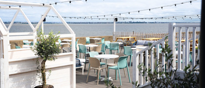 The decked outdoor terrace area at Kent Coast Yacht Club looks out over the Thames estuary.