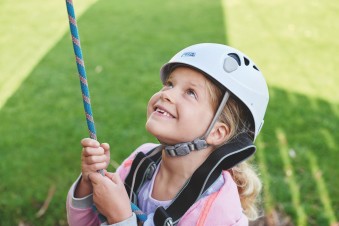 Helmet and ropes at the ready before you take to the climbing wall