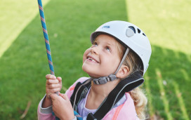 Helmet and ropes at the ready before you take to the climbing wall