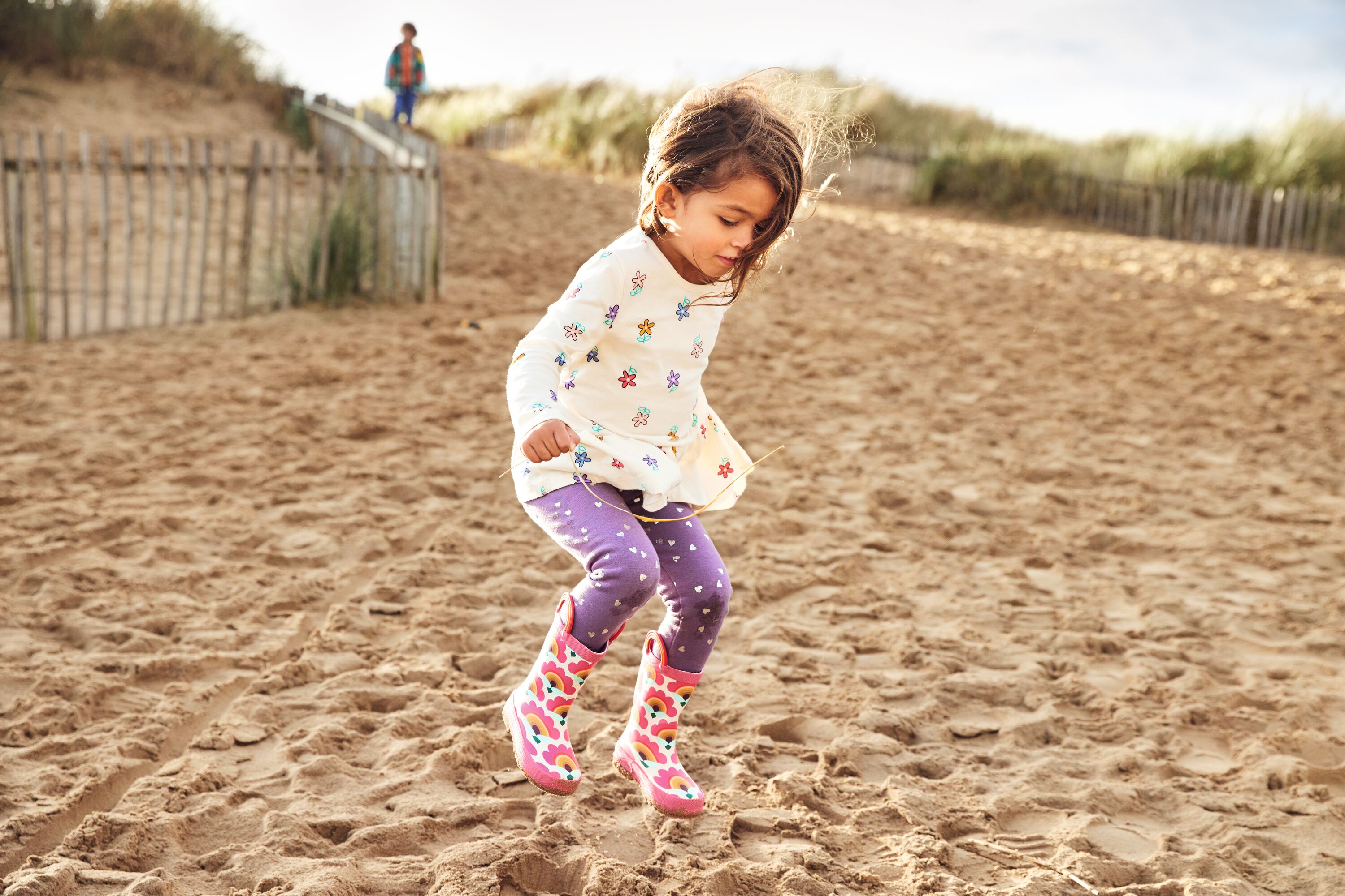 A girl jumps on the sandy beach in her wellies near Haven Golden Sands, Mablethorpe.
