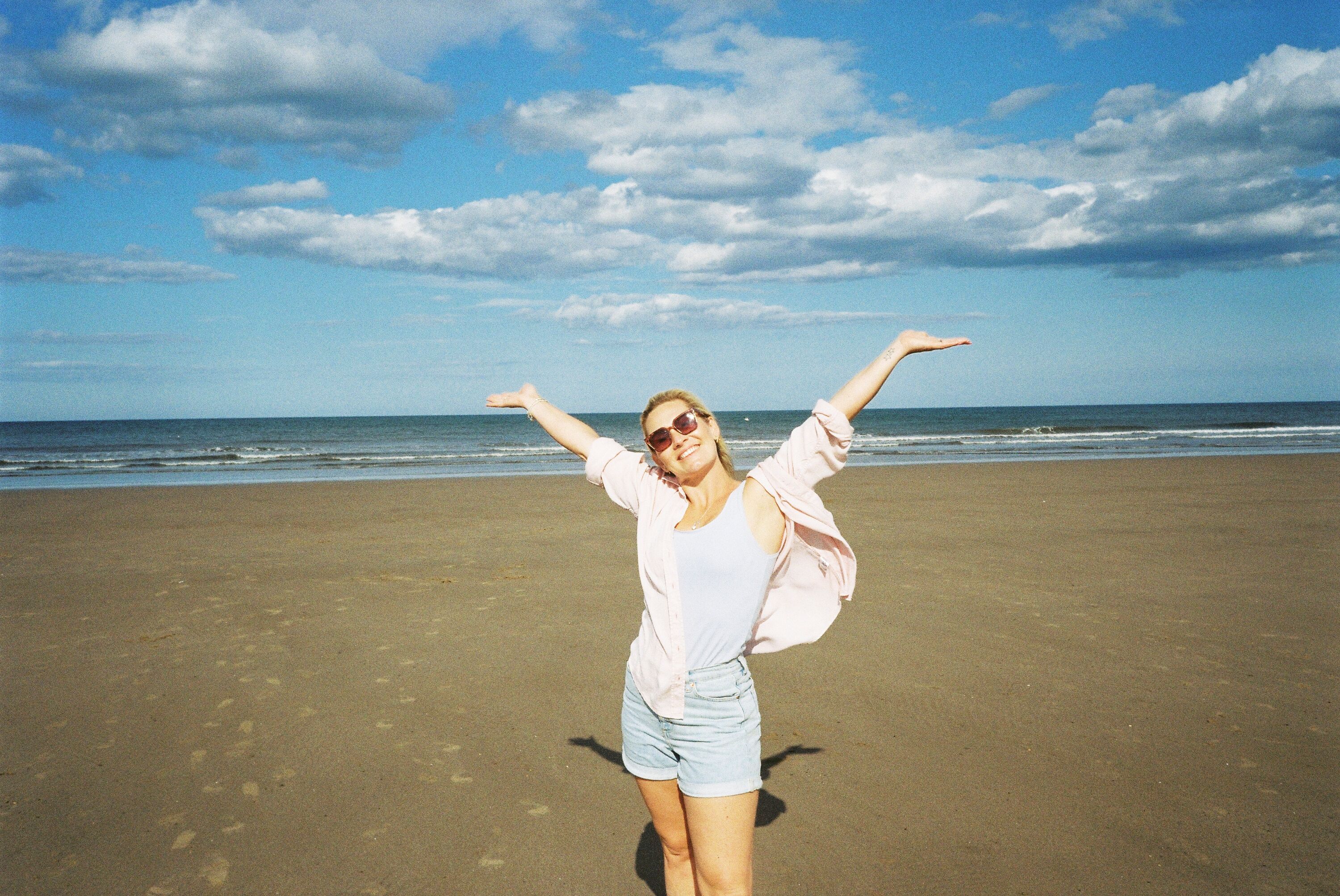A woman has her photograph taken on a beach near Primrose Valley, Yorkshire.