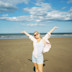 A woman has her photograph taken on a beach near Primrose Valley, Yorkshire.
