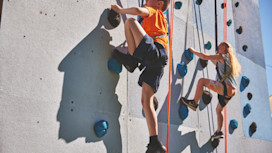 Helmet and ropes at the ready before you take to the climbing wall
