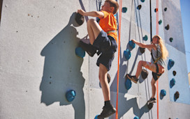 Helmet and ropes at the ready before you take to the climbing wall