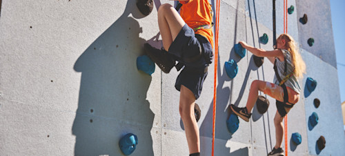 Helmet and ropes at the ready before you take to the climbing wall