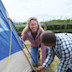 A couple setting up a tent at Littlesea holiday park.