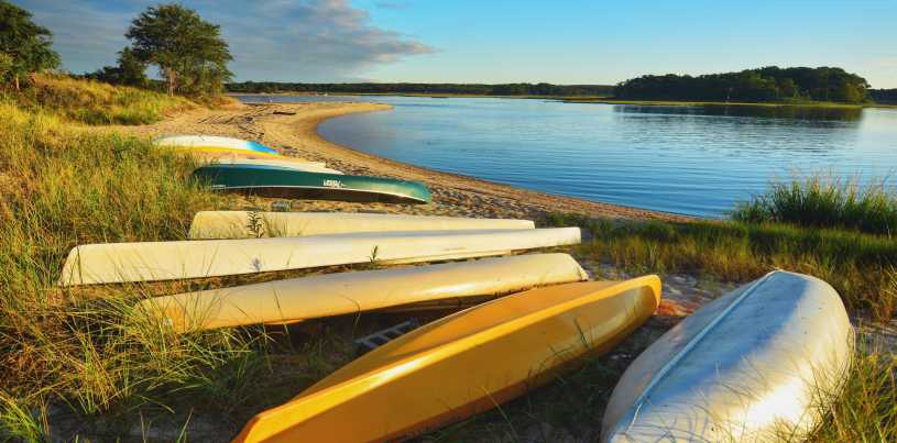 Kayaks and canoes pulled onto the shore for the winter season