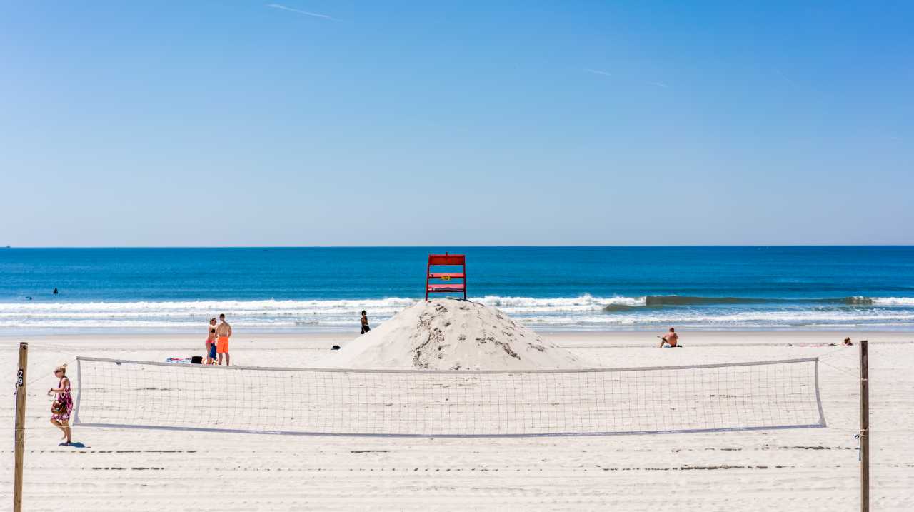 Beach volleyball net set up in back of lifeguard chair on Long Beach