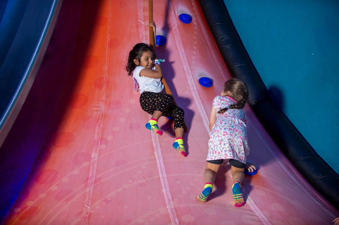 Two children play indoors at Urban Air Adventure Park in Lake Grove