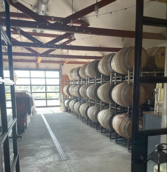 Barrels of wine in the 125-year-old barn at Rose Hill Vineyard