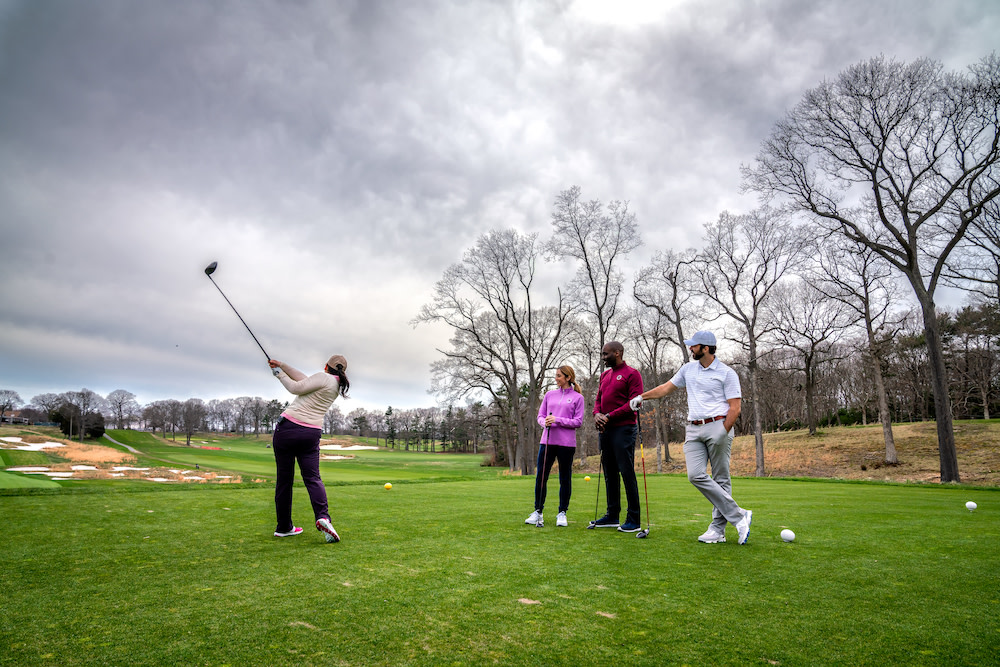 Foursome teeing off at Bethpage Golf Course