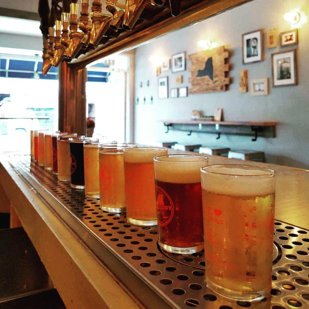 A flight of beer on the tap counter at Lithology Brewing