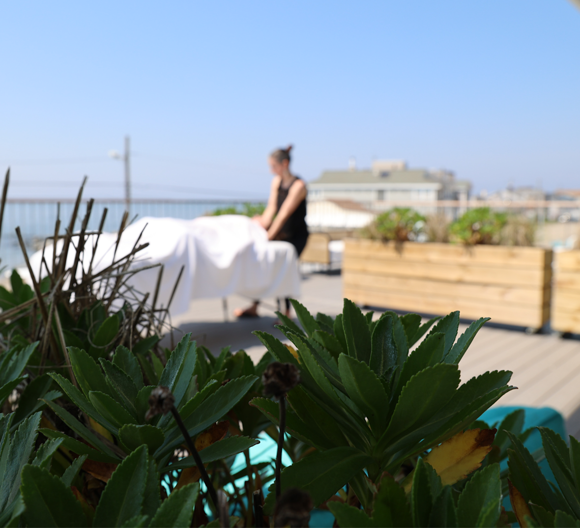Outdoor massage table on deck at Arogya in Stratford