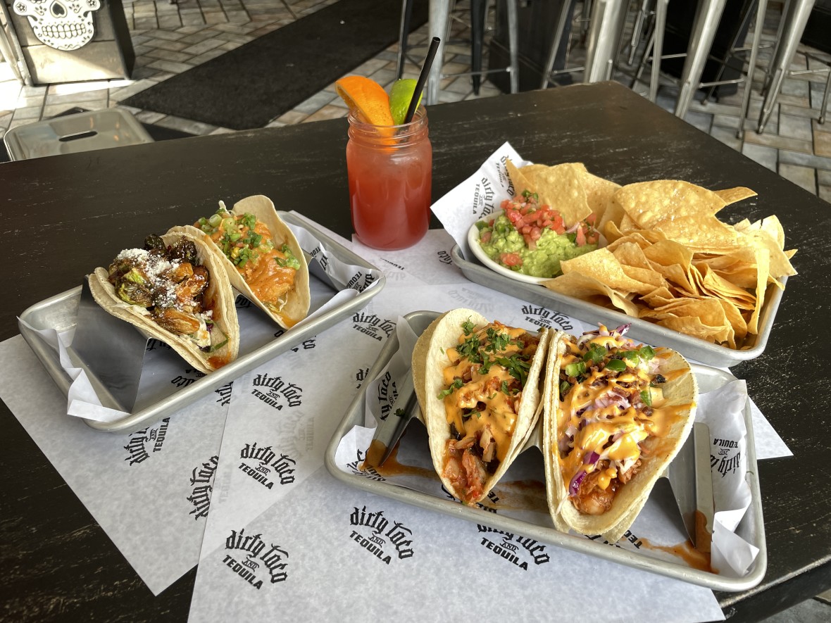 Four tacos and a side of chips and guacamole at Dirty Taco & Tequila in Rockville Centre