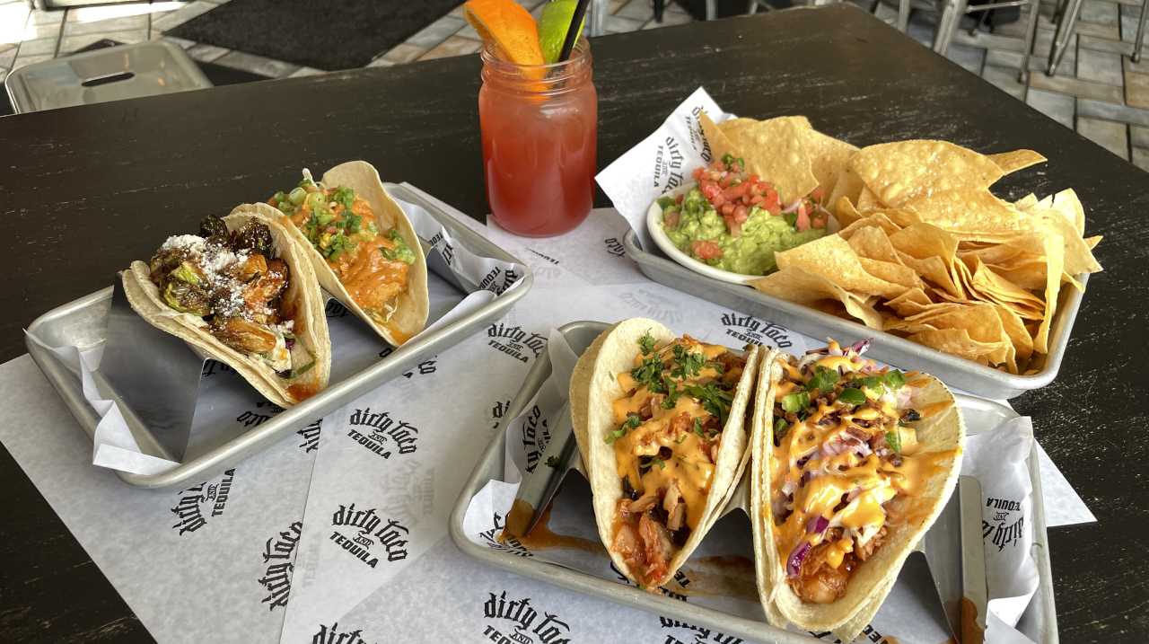 Four tacos and a side of chips and guacamole at Dirty Taco & Tequila in Rockville Centre