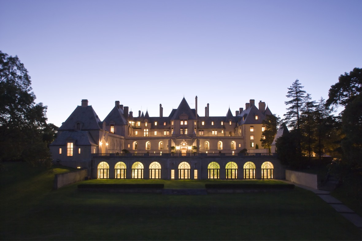 Lights of Oheka Castle shining at dusk