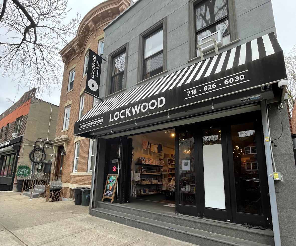 Exterior of Lockwood in Astoria, Queens with black and white striped awning
