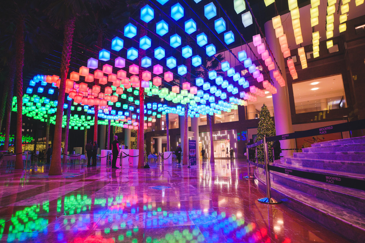 Illuminated squares in a rainbow of colors suspended from the ceiling of Luminaries light show at Brookfield Place