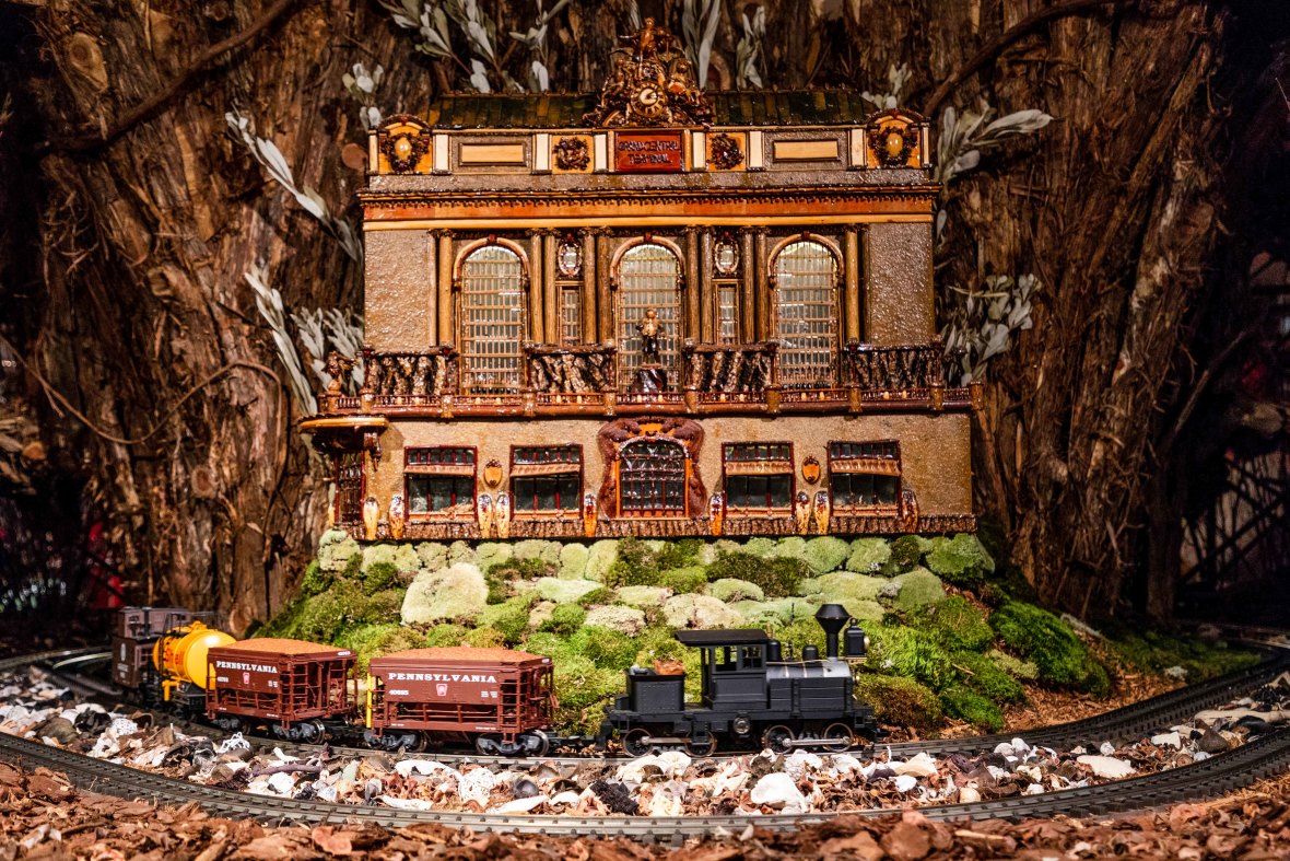 Model train passing miniature Grand Central Terminal at NYBG's holiday train show
