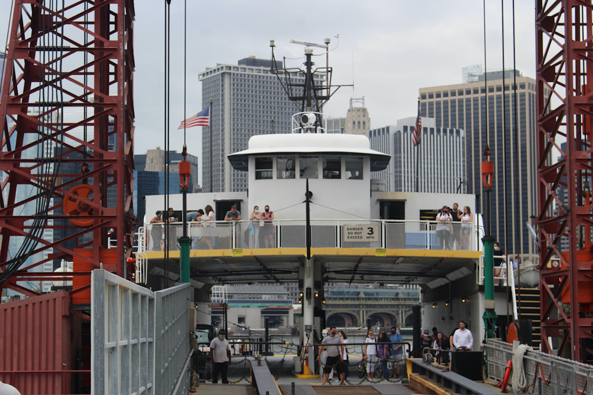 Ferry boat docked with NYC skyline in background