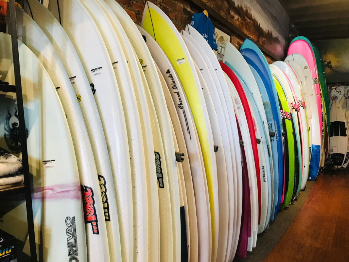 Surfboards lined up against each other in a row