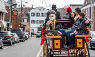 Group takes holiday carriage ride down a village's Main Street