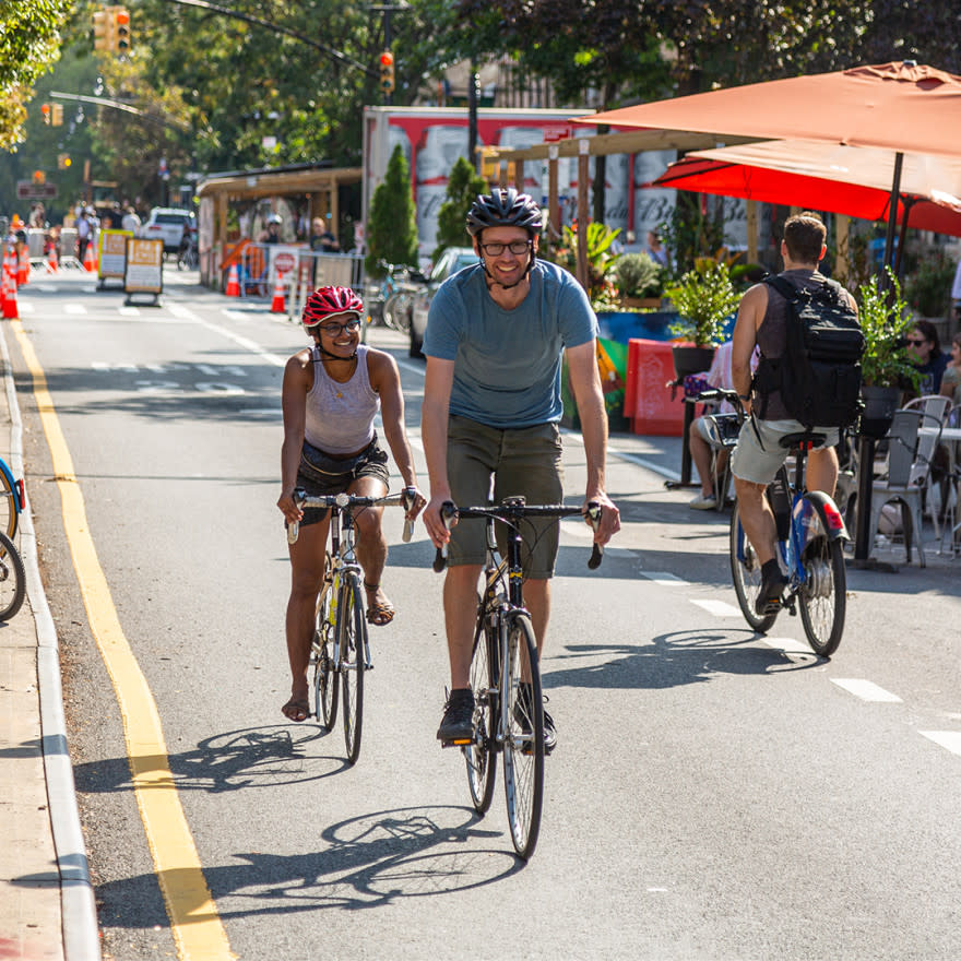 Two individuals biking down open NYC street during Car Free Earth Day 2021