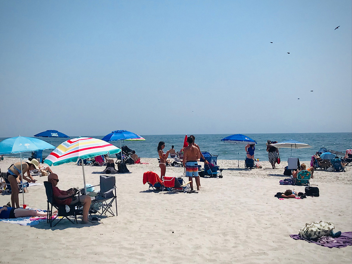 Beachgoers under their umbrellas at Long Beach