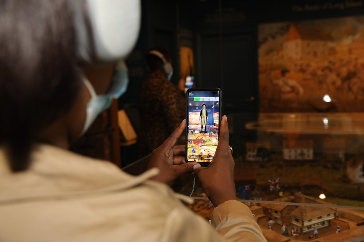 A visitor using the self-guided tour app at the Raynham Hall Museum