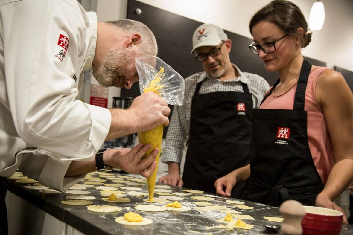 Zwilling Cooking Studio's chef demonstrating ravioli filling in front of two students