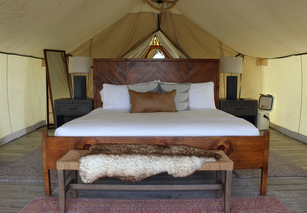 Comfy king-size bed in a Collective Retreats tent
