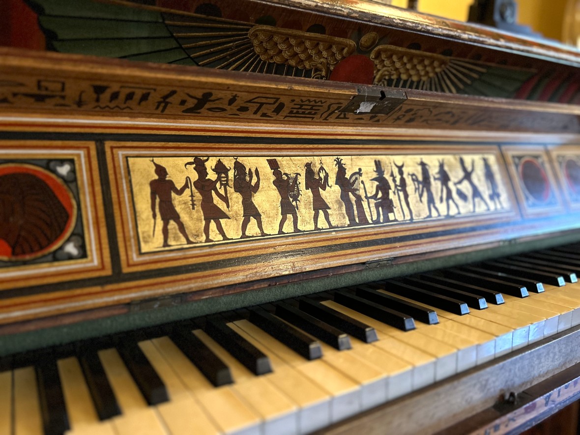 Egyptian Revival spinet piano closeup