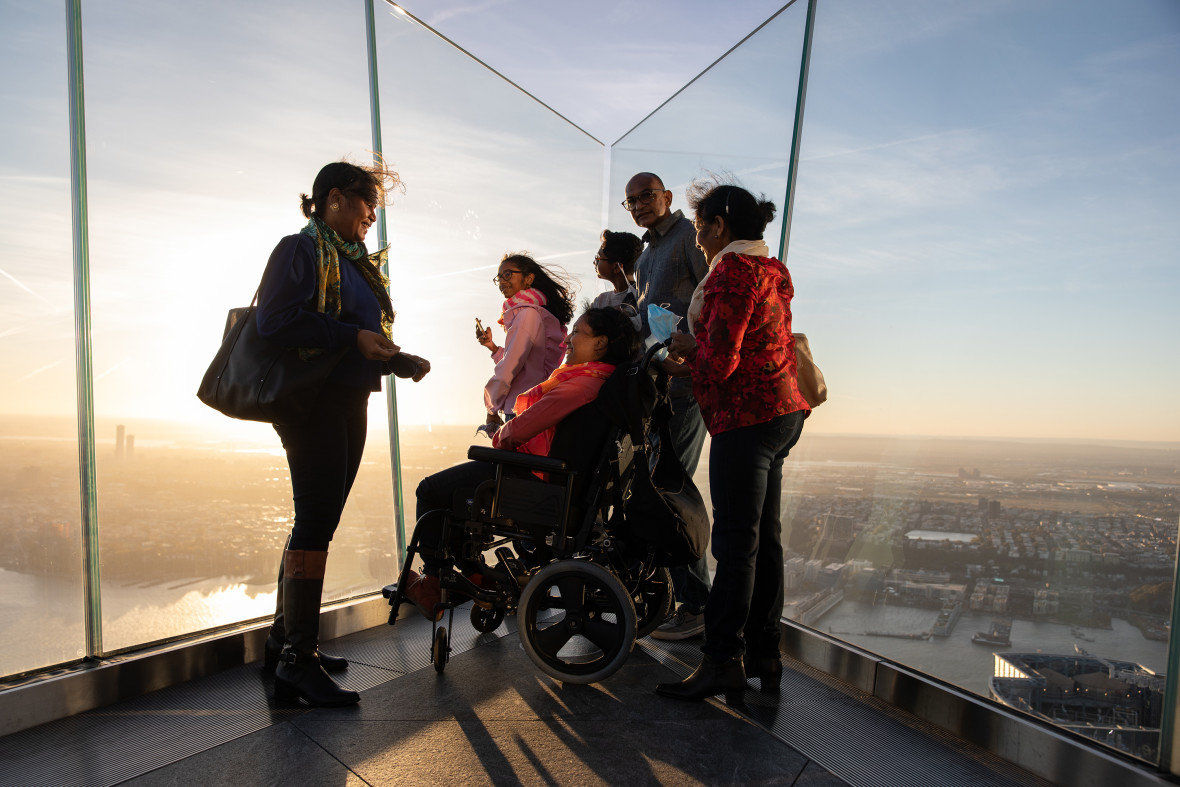 Group of people including a person using a wheelchair admiring the view from Edge NYC