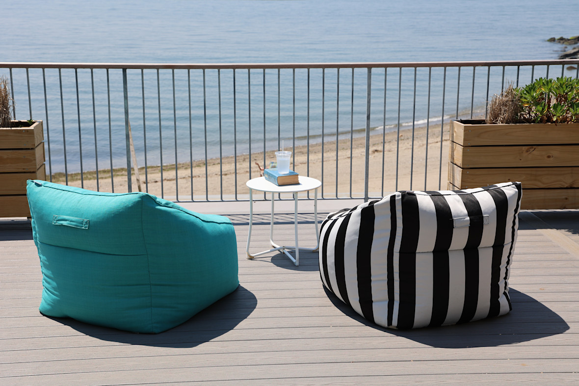 Beanbag chairs on deck facing ocean shoreline