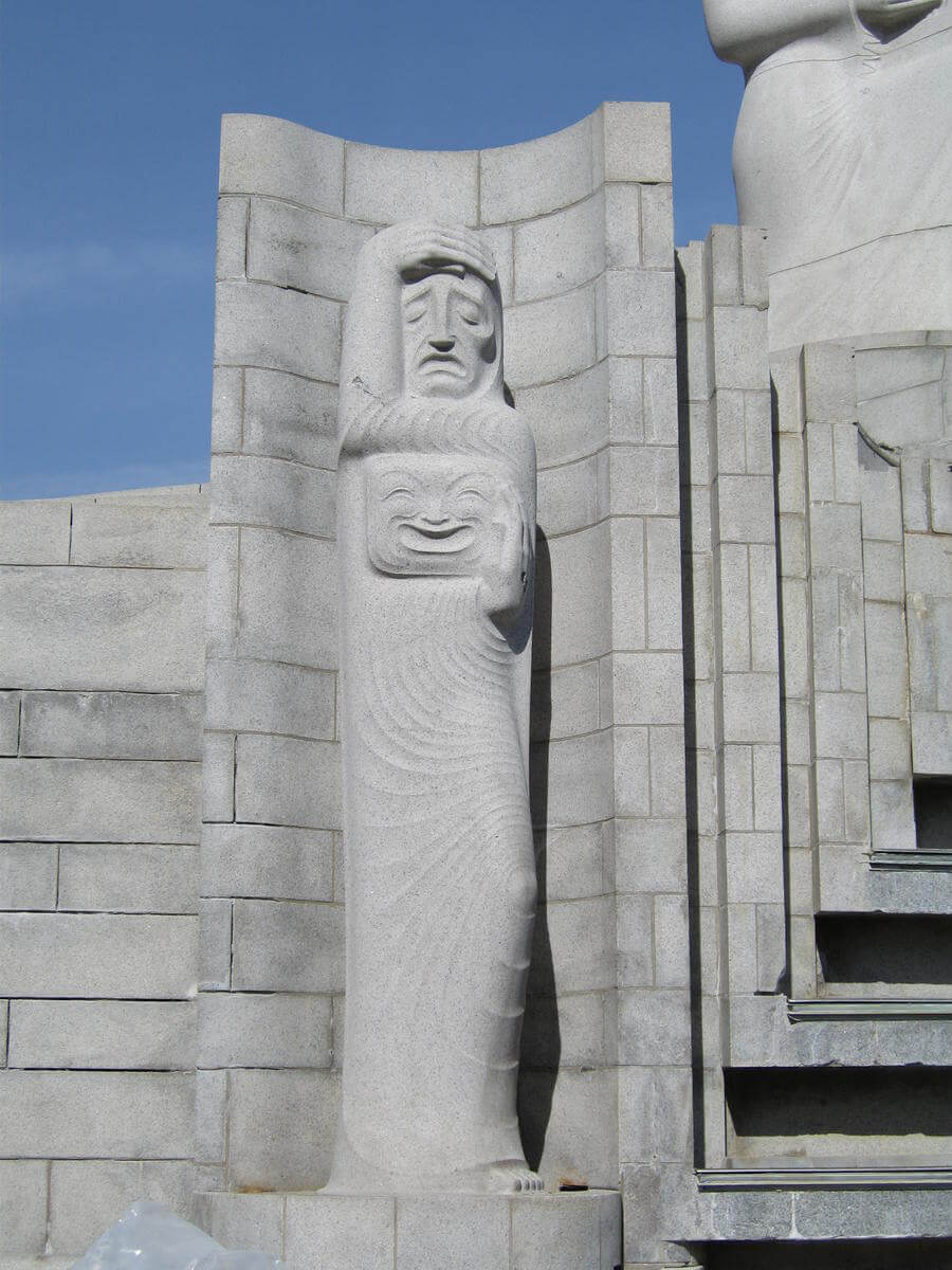 The Muse of Drama, one of the two smaller statues attached to the fountain’s base