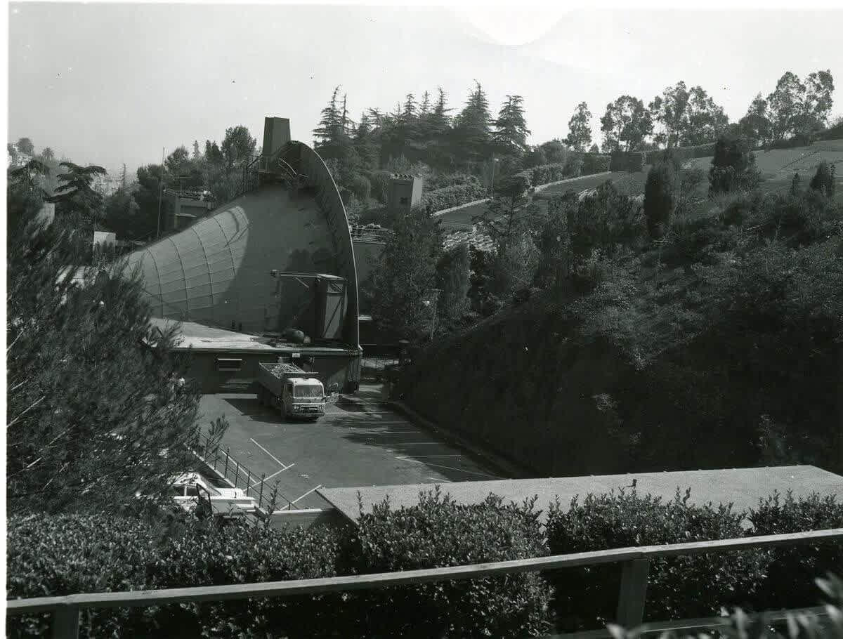 Hollywood Bowl shell pulled into the side backstage parking area by a weighted truck, 1962.