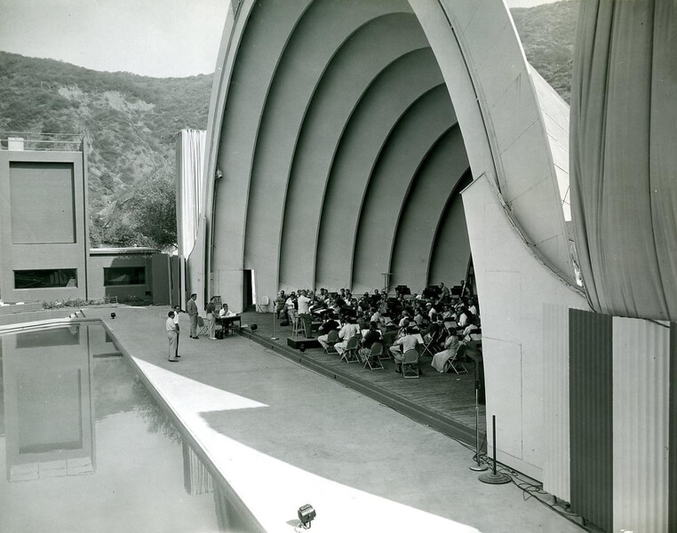 Musicians rehearse just a few feet from the water’s edge on a hot summer morning, ca. 1960