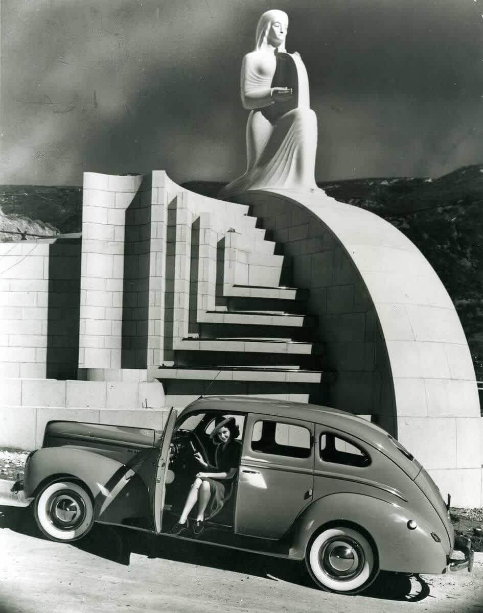 A woman steps out of a 1940 Ford, parked in front of the Muse of Music