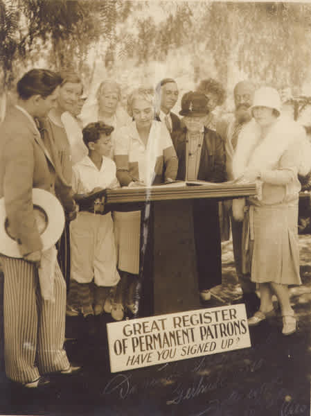 Artie Mason Carter (center) helps the Bowl’s oldest permanent patron (“Grandma” E. J. Wakeman) and its youngest (Philippe de Lacey) sign the Great Register of Permanent Patrons