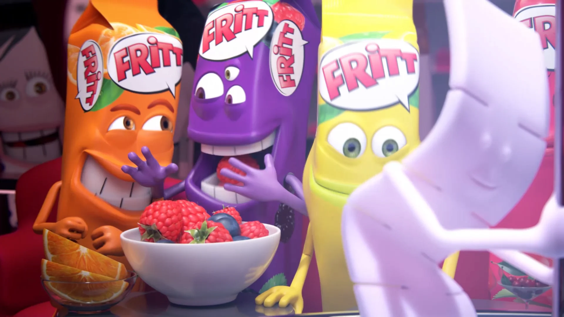 close up of three different colored fritt-shaped characetes sitting next to each other. a peel of fruits in front of them. two are giggling and one is looking at the pole-dancing gum stripe