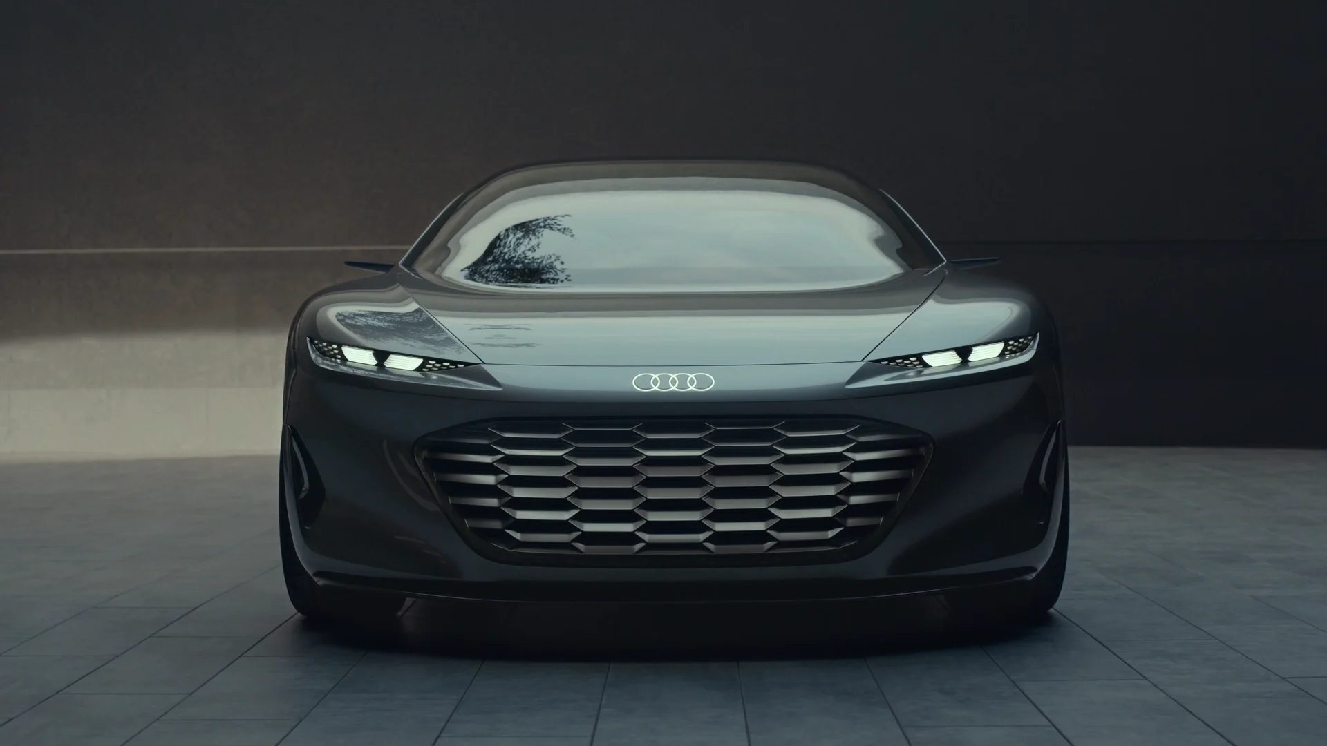 a black audi concept car in a concrete textured room with some light coming from above