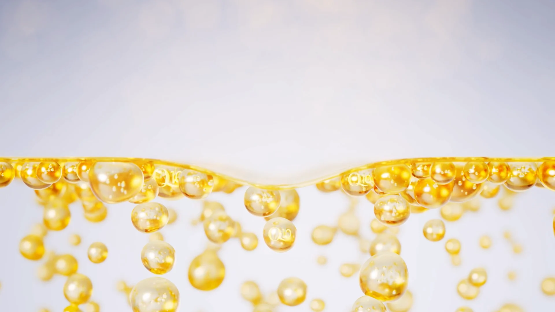 several golden bubbles with littel Q10 letters on it swimming in a transparent liquid